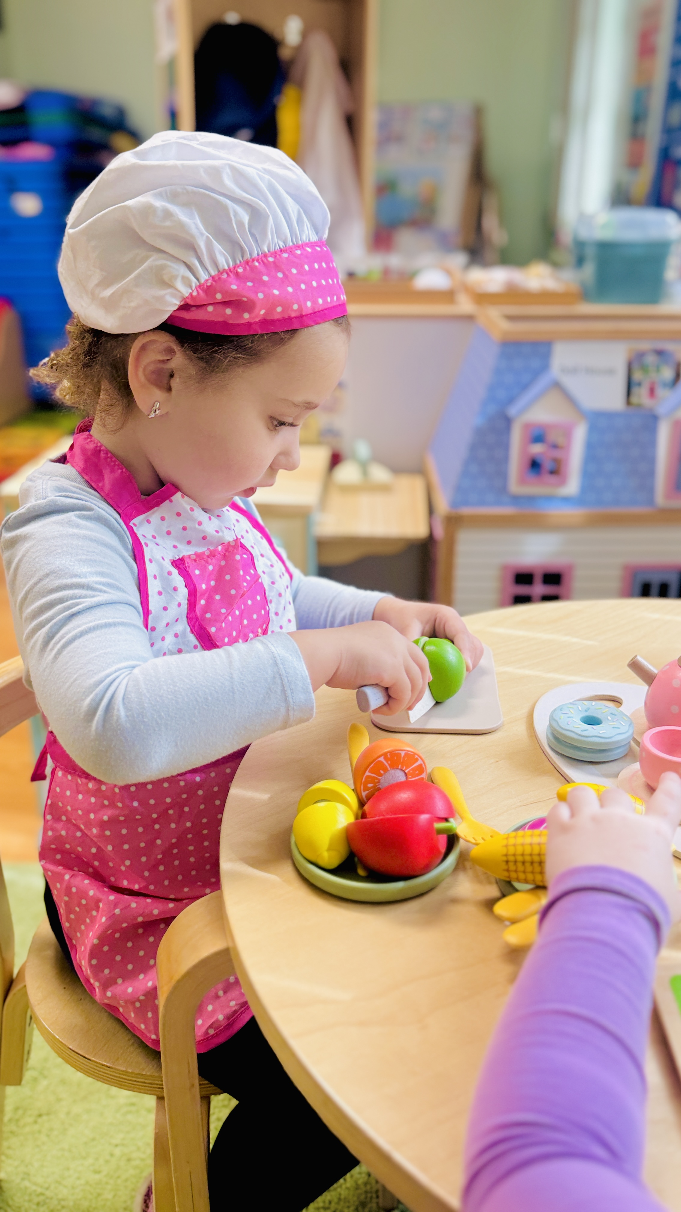Girl in chef hat during cooking class