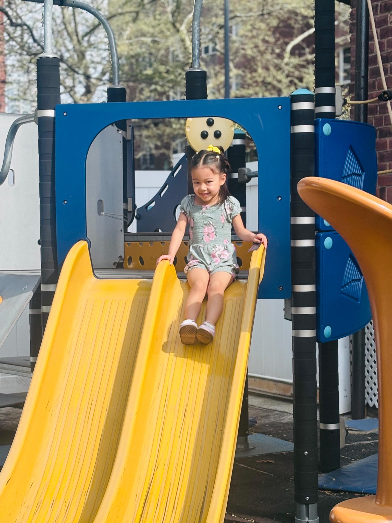 Girl enjoying the outdoor playground slide